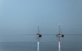 Two boats over the moonlight. Two anchored ships in the open sea under the moonlight