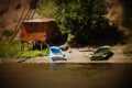 Two boats on the river Bank near a large metal garage