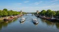 Two Boats on a River Passing Under a Bridge with Towers Royalty Free Stock Photo