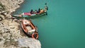 Two boats on the shore of the lake saif ul malook, leaving behind the stunning and beautiful water.