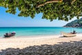 Two boats at the white sand paradise beach of the tropical blue sea. Daytime, Andaman Sea, Koh Phangan, Thailand