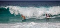 Two bodyboarders riding together