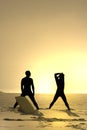 Two bodyboarders at sunset Royalty Free Stock Photo
