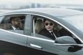 two bodyguards and businessman in glasses sitting in a black Royalty Free Stock Photo