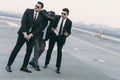 two bodyguards in sunglasses protecting businessman Royalty Free Stock Photo