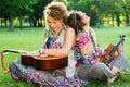 Two Bohemian Musicians sitting on the grass Royalty Free Stock Photo