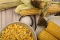 Two boiled ears of corn, corn kernels, coarse salt and raw ears of corn on a wooden table. Fitness diet. Healthy diet. For a sweet Royalty Free Stock Photo