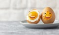 Two boiled eggs with cheerful smiling faces make for a playful and nutritious breakfast scene. Royalty Free Stock Photo