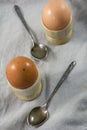 Two boiled eggs in egg cups with spoons Royalty Free Stock Photo