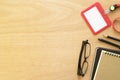 Two books, paperclip, pencil, pen, employee card, and eye glasses on rustic brown wooden desk. Lifestyle workspace, top view Royalty Free Stock Photo