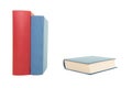 Two books red and blue standing and a blue book lying down on a white background Royalty Free Stock Photo