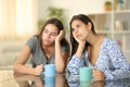 Two bored friends drinking coffee at home Royalty Free Stock Photo