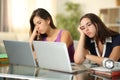 Two bored students waiting online content at home Royalty Free Stock Photo