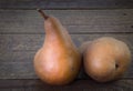 Two Bosc pears on rustic wooden background Royalty Free Stock Photo