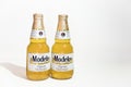 Two bottle of Modelo on a white background.