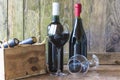 Two bottle of red wine and glasses on rustic wooden background Royalty Free Stock Photo