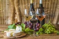 Two bottle of wine and three glasses of white, pink and red wine Royalty Free Stock Photo