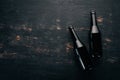 Two bottles of beer On a black wooden table. Royalty Free Stock Photo