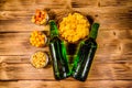 Two bottles of beer and different snacks on wooden table. Top view Royalty Free Stock Photo