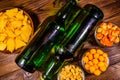 Two bottles of beer and different snacks on wooden table. Top view Royalty Free Stock Photo