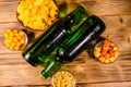 Two bottles of beer and different snacks on wooden table. Top view Royalty Free Stock Photo