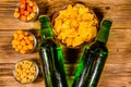 Two bottles of beer and different snacks on wooden table. Top view Royalty Free Stock Photo