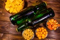 Two bottles of beer and different snacks on wooden table. Top view Royalty Free Stock Photo