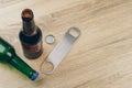 Two bottles of beer and a stainless steel bottle opener Royalty Free Stock Photo