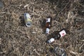 Two bottles and can of beer discharded into grass Royalty Free Stock Photo