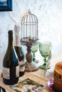 Two bottles of champagne, Easter eggs in a decorative cage and glasses on the table Royalty Free Stock Photo