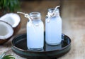 Two bottles of coconut water on a wooden table Royalty Free Stock Photo