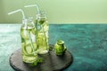 Two bottles of cucumber infused water on table Royalty Free Stock Photo