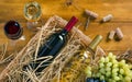 Two bottles, glasses of wine, bunches of grapes on wooden table Royalty Free Stock Photo