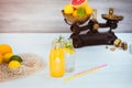 Two bottles with homemade lemonade and orange fresh juice with mint and ice on the white wooden background with fresh citrus in Royalty Free Stock Photo