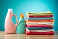 Two Bottles of Laundry Detergent Beside a Stack of Folded Colorful Clothes image photo Royalty Free Stock Photo