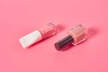 Two bottles of luxury nail polish on pink background Royalty Free Stock Photo