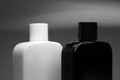 Two bottles of man perfume on grey background