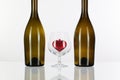 Two bottles and red heart inside a glass of cognac Royalty Free Stock Photo