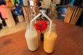 Two bottles of sweet fruit smoothies, on the table of a popular cafe. Concept of healthy dates and relations.