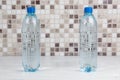 Two bottles of water on white table Royalty Free Stock Photo