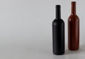 Two bottles of wine of black and red on a white background Royalty Free Stock Photo