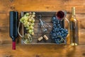 Two bottles of wine and grapes in  box on  wooden background Royalty Free Stock Photo