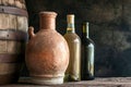 Two Bottles of Wine Next to Barrel in Cellar Royalty Free Stock Photo