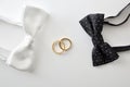Two bow ties with on the sides of wedding rings Royalty Free Stock Photo