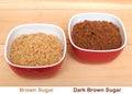 Two bowls of brown and dark brown sugar