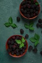 Two bowls, fresh , ripe blackberries, with leaves, top view, no people,