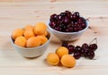 Two bowls full of fresh apricots and cherries berries Royalty Free Stock Photo