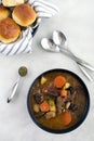 Bowls of Italian Beef Stew with Dinner Rolls