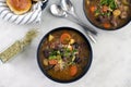 Bowls of Italian Beef Stew with Dinner Rolls