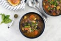 Bowls of Italian Beef Stew with Dinner Rolls